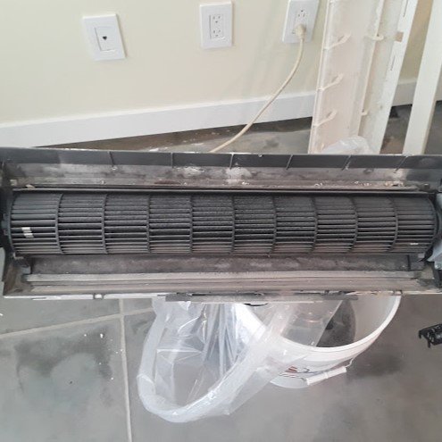 Technician inspecting an AC system.