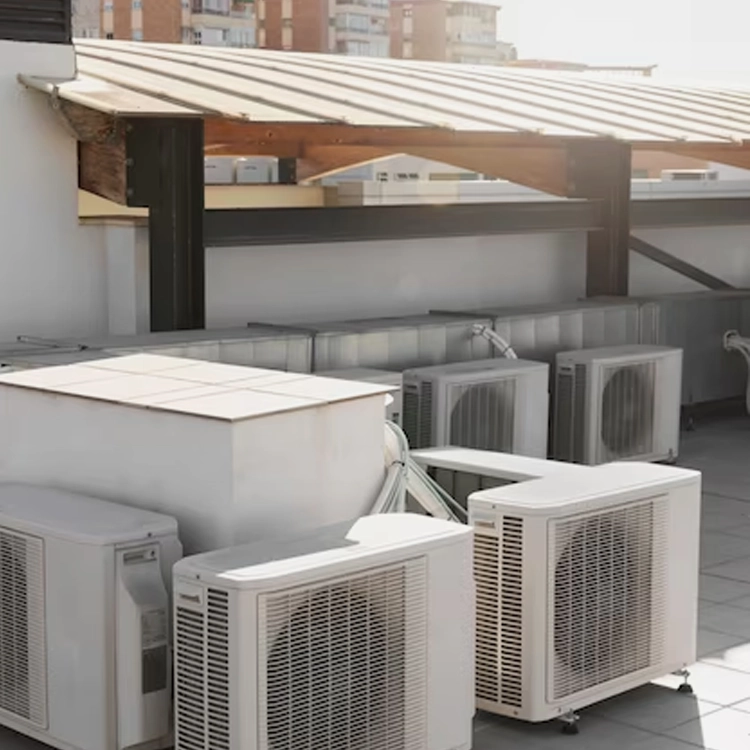 Multiple outdoor air conditioning units lined up on a rooftop, providing cooling for a commercial building